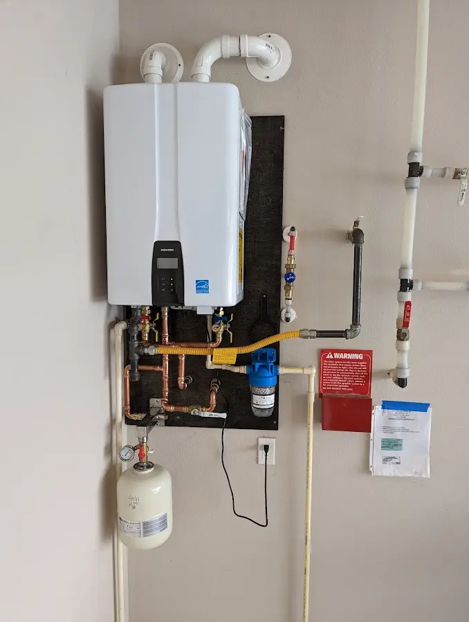 Professional plumber installing copper piping in a King George home